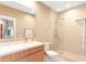 Bright bathroom featuring a glass-enclosed shower, modern vanity and neutral tones at 7478 Brooklyn Dr, Kissimmee, FL 34747