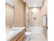 Bathroom featuring a shower-tub combination with a glass door, and light wood vanity at 7478 Brooklyn Dr, Kissimmee, FL 34747