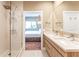 Modern bathroom showcasing a glass shower, double vanity, and natural light at 7478 Brooklyn Dr, Kissimmee, FL 34747