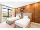 Bedroom with two twin beds and a rustic wooden accent wall with an anchor clock at 7478 Brooklyn Dr, Kissimmee, FL 34747
