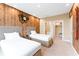 Well-lit bedroom with two twin beds, wood accent wall, en-suite bath and closet at 7478 Brooklyn Dr, Kissimmee, FL 34747