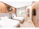 Bedroom featuring a wall with rustic wood panels, two twin beds, and decorative ski decor at 7478 Brooklyn Dr, Kissimmee, FL 34747