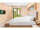 Bedroom with a large window that provides natural light and a view of the landscaped yard at 7478 Brooklyn Dr, Kissimmee, FL 34747