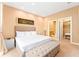 Well-lit bedroom featuring a king bed, a large area rug, and access to a walk-in closet at 7478 Brooklyn Dr, Kissimmee, FL 34747