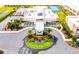 Aerial view of a modern clubhouse with well-manicured landscaping and a circular driveway at 7478 Brooklyn Dr, Kissimmee, FL 34747