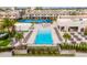 Overhead view of the community pool with lounge chairs, nearby tennis courts and other amenities at 7478 Brooklyn Dr, Kissimmee, FL 34747