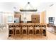 Contemporary kitchen showcasing a spacious island with bar seating, stainless steel appliances, and modern lighting at 7478 Brooklyn Dr, Kissimmee, FL 34747