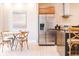 Bright eat-in kitchen area with stainless steel refrigerator and a cozy breakfast table for four at 7478 Brooklyn Dr, Kissimmee, FL 34747