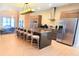 Modern kitchen featuring a large island with seating, stainless steel appliances, and sleek cabinetry at 7478 Brooklyn Dr, Kissimmee, FL 34747