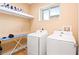 Functional laundry room with a washer, dryer, and ample storage, offering convenience and organization at 7478 Brooklyn Dr, Kissimmee, FL 34747