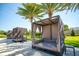 Relaxing outdoor lounge areas with shaded daybeds for unwinding in the Florida sunshine at 7478 Brooklyn Dr, Kissimmee, FL 34747