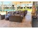 Outdoor community lounge area with plush seating, modern décor, and views of the building at 7478 Brooklyn Dr, Kissimmee, FL 34747