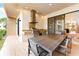 Covered outdoor kitchen includes a built-in grill, sink, and a large dining table, perfect for outdoor entertaining at 7478 Brooklyn Dr, Kissimmee, FL 34747