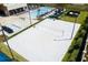 Aerial view of a community volleyball court with white sand, near a pool and modern lounge area at 7478 Brooklyn Dr, Kissimmee, FL 34747