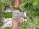 Aerial view of the home surrounded by mature trees and an overgrown backyard at 809 Sugar House Blvd, Port Orange, FL 32129