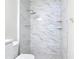Shower in the bathroom has marble tile and chrome shower head and fixture at 809 Sugar House Blvd, Port Orange, FL 32129
