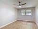 Bedroom featuring wood-look floors, a ceiling fan, and a window with blinds at 809 Sugar House Blvd, Port Orange, FL 32129
