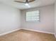 Bright bedroom featuring wood-look floors, a ceiling fan, and a window with blinds at 809 Sugar House Blvd, Port Orange, FL 32129