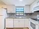 Updated kitchen with granite countertops, white cabinetry, stainless appliances, and modern backsplash at 809 Sugar House Blvd, Port Orange, FL 32129