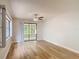 Bright living room featuring wood-look floors, a ceiling fan, and sliding glass doors to screened patio at 809 Sugar House Blvd, Port Orange, FL 32129