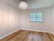 Bright living room featuring wood-look floors, natural lighting, and a stylish light fixture at 809 Sugar House Blvd, Port Orange, FL 32129