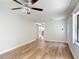 Large living room with wood-look floors, ceiling fan, and windows providing natural light, with entry door to right at 809 Sugar House Blvd, Port Orange, FL 32129