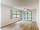 Spacious living room with wood floors, large windows, and sliding glass doors to the screened in patio at 809 Sugar House Blvd, Port Orange, FL 32129