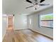 An open living room with modern ceiling fan, wood-look flooring, and natural light from the backyard window at 809 Sugar House Blvd, Port Orange, FL 32129