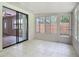 Enclosed porch featuring tile flooring, access to the backyard, and sliding glass doors at 809 Sugar House Blvd, Port Orange, FL 32129