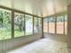 Enclosed porch surrounded with windows overlooking the backyard and storage shed at 809 Sugar House Blvd, Port Orange, FL 32129