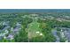 A high aerial perspective overlooks a community and golf course, highlighting the green fairways and residences at 875 Bentley Green Cir, Winter Springs, FL 32708