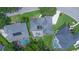 Aerial view of a house with a screened pool, surrounded by lush greenery at 875 Bentley Green Cir, Winter Springs, FL 32708