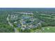 Overhead view of a community featuring single-Gathering homes, lush landscaping, and a nearby golf course at 875 Bentley Green Cir, Winter Springs, FL 32708