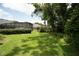 Expansive backyard features a large screened-in lanai, mature trees, and a well-maintained lawn at 875 Bentley Green Cir, Winter Springs, FL 32708
