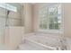 Bright bathroom showcasing a glass shower and a large soaking tub at 875 Bentley Green Cir, Winter Springs, FL 32708