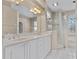 Bathroom with double sinks, a large mirror, and glass-enclosed shower at 875 Bentley Green Cir, Winter Springs, FL 32708