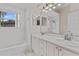 Bathroom with double sink vanity, a tub, and ample lighting at 875 Bentley Green Cir, Winter Springs, FL 32708