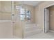 Bathroom featuring a glass shower and a luxurious soaking tub at 875 Bentley Green Cir, Winter Springs, FL 32708