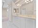 Bright bathroom featuring a double sink vanity and white tile flooring at 875 Bentley Green Cir, Winter Springs, FL 32708