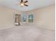 Open bedroom with a ceiling fan and windows offering a view of the lanai at 875 Bentley Green Cir, Winter Springs, FL 32708