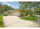 Beautiful home with a spacious driveway, manicured lawn, and lush trees, perfect for suburban living at 875 Bentley Green Cir, Winter Springs, FL 32708
