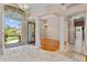 Open foyer with stone floors and an arched ceiling seamlessly connects the space to the rest of the home at 875 Bentley Green Cir, Winter Springs, FL 32708