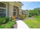 Inviting front entrance with landscaped walkway and colorful foliage, creating curb appeal at 875 Bentley Green Cir, Winter Springs, FL 32708