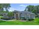 Charming single-story home with lush lawn and colorful, well-maintained landscaping at 875 Bentley Green Cir, Winter Springs, FL 32708