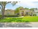 Stunning one-story home with manicured lawn, vibrant plants, and a grand entrance at 875 Bentley Green Cir, Winter Springs, FL 32708