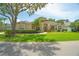 Beautiful single-story home with lush green lawn, mature landscaping, and a welcoming entrance at 875 Bentley Green Cir, Winter Springs, FL 32708