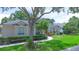 Charming single-story home with lush lawn and colorful, well-maintained landscaping at 875 Bentley Green Cir, Winter Springs, FL 32708
