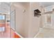 Hallway with closet leading into living space with hardwood floors and fireplace at 875 Bentley Green Cir, Winter Springs, FL 32708