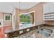 Kitchen with granite countertops and a sink overlooking the screened-in pool area and outdoor living space at 875 Bentley Green Cir, Winter Springs, FL 32708