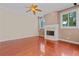 Bright living room features a fireplace, hardwood floors, and a ceiling fan at 875 Bentley Green Cir, Winter Springs, FL 32708